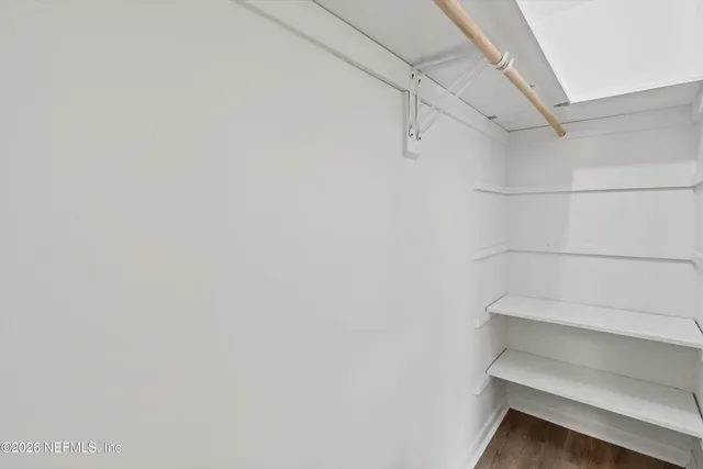 a view of walk in closet with empty racks