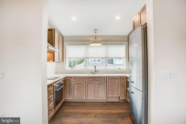 a view of a kitchen with a sink and dishwasher refrigerator