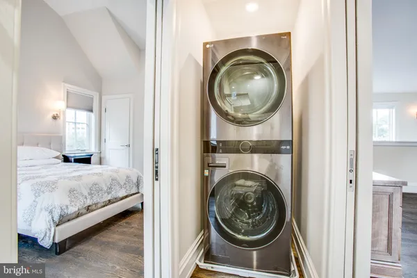a view of a bedroom with washer and dryer