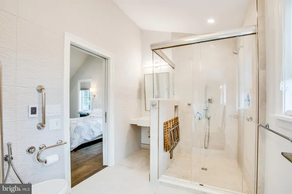 a bathroom with a glass shower door and a glass door