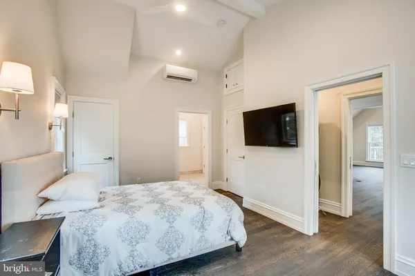 a bedroom with a bed and a flat screen tv