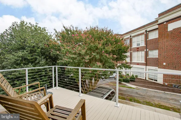 a view of a balcony with wooden floor and city view