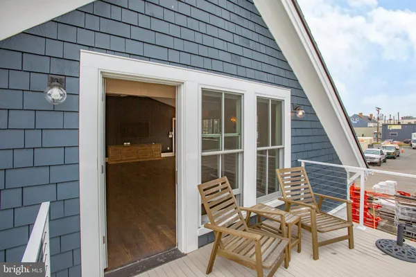 a balcony with furniture and a potted plant