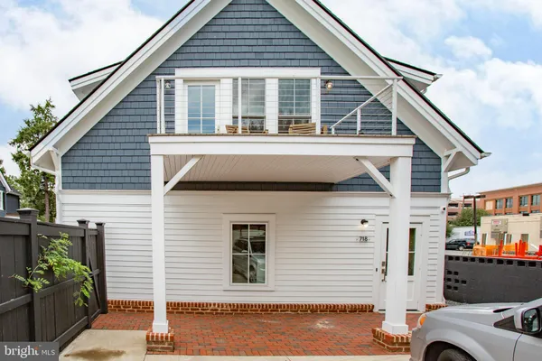 a view of a house with a garage and balcony