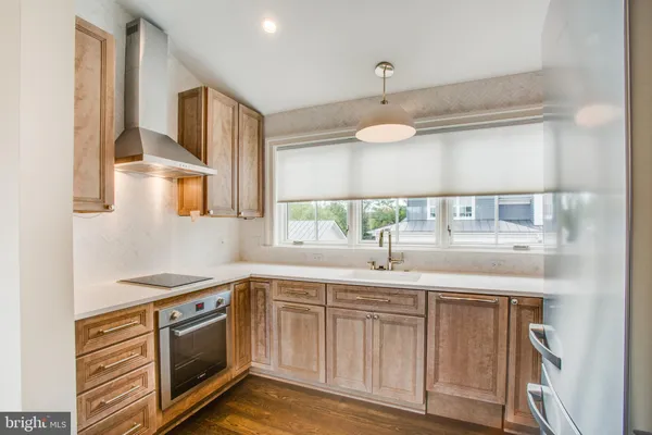 a kitchen with stainless steel appliances granite countertop a sink and cabinets