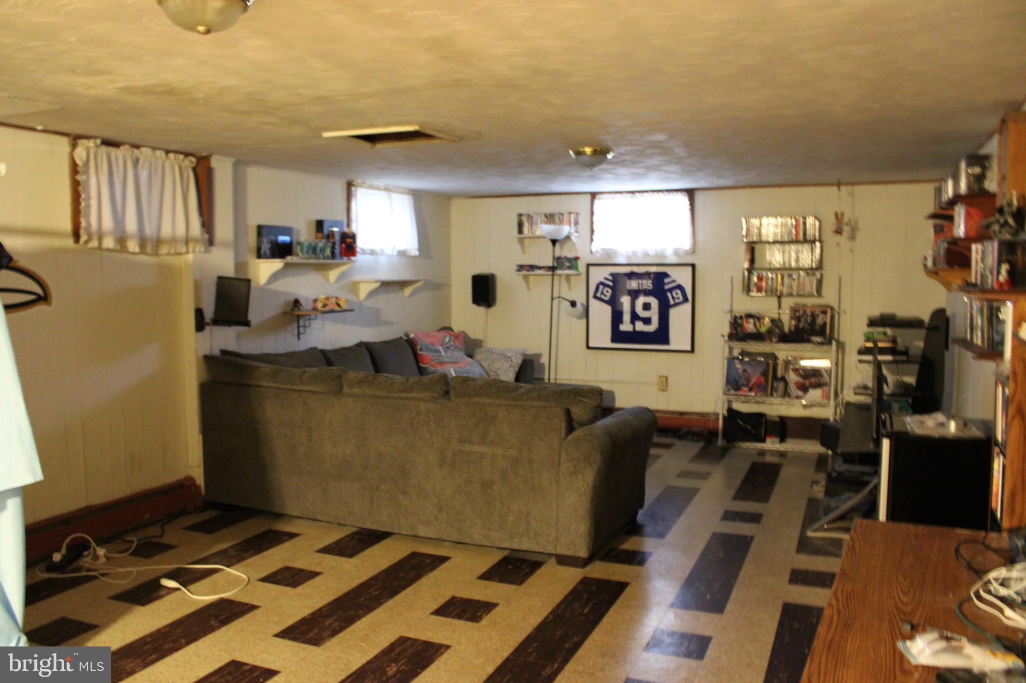 6036 Chesworth Road Baltimore, MD 21228 - Photo 15 of 15 a living room with furniture and a flat screen tv