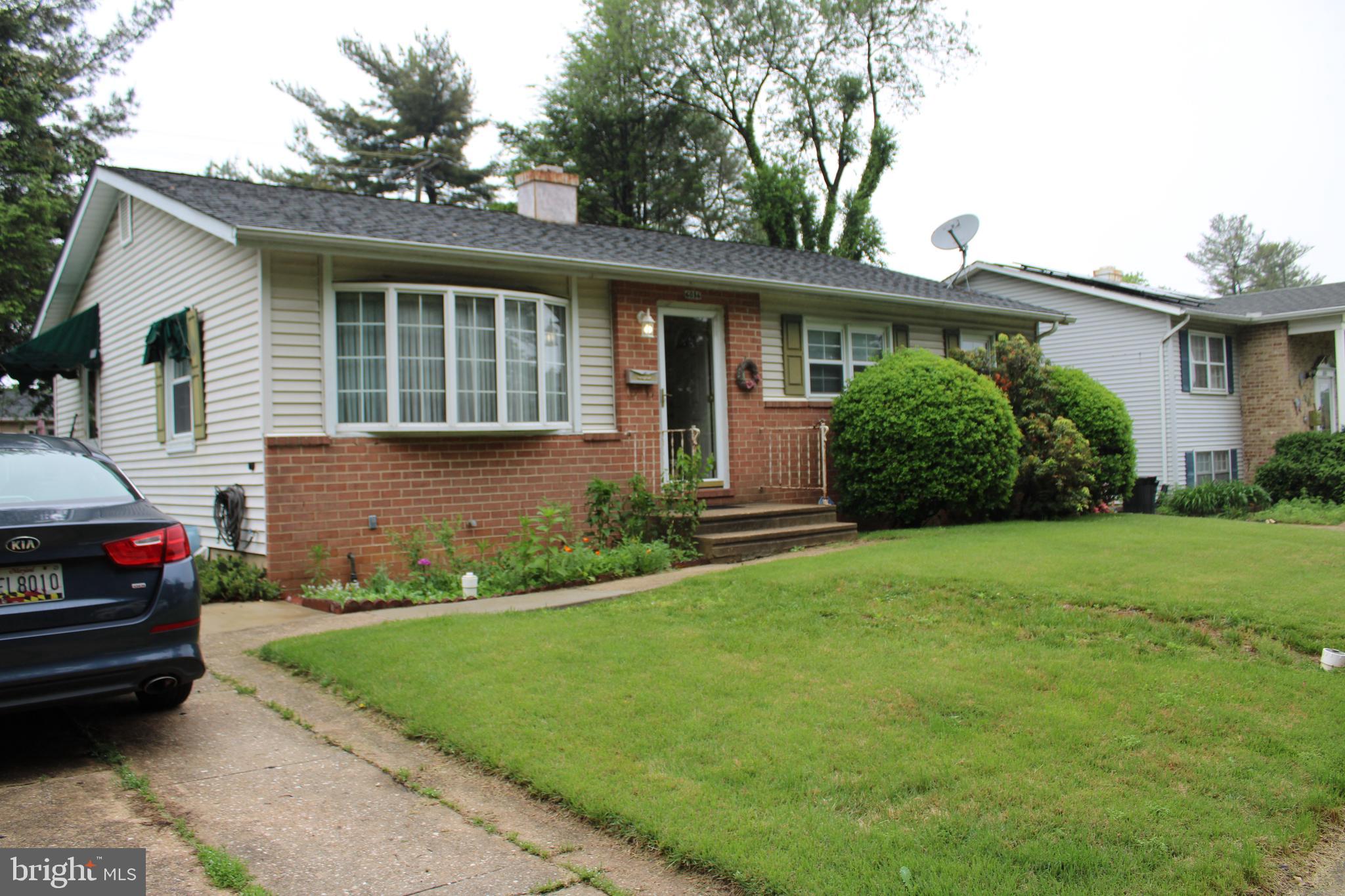 6036 Chesworth Road Baltimore, MD 21228 - Photo 3 of 15 a front view of a house with a garden and plants