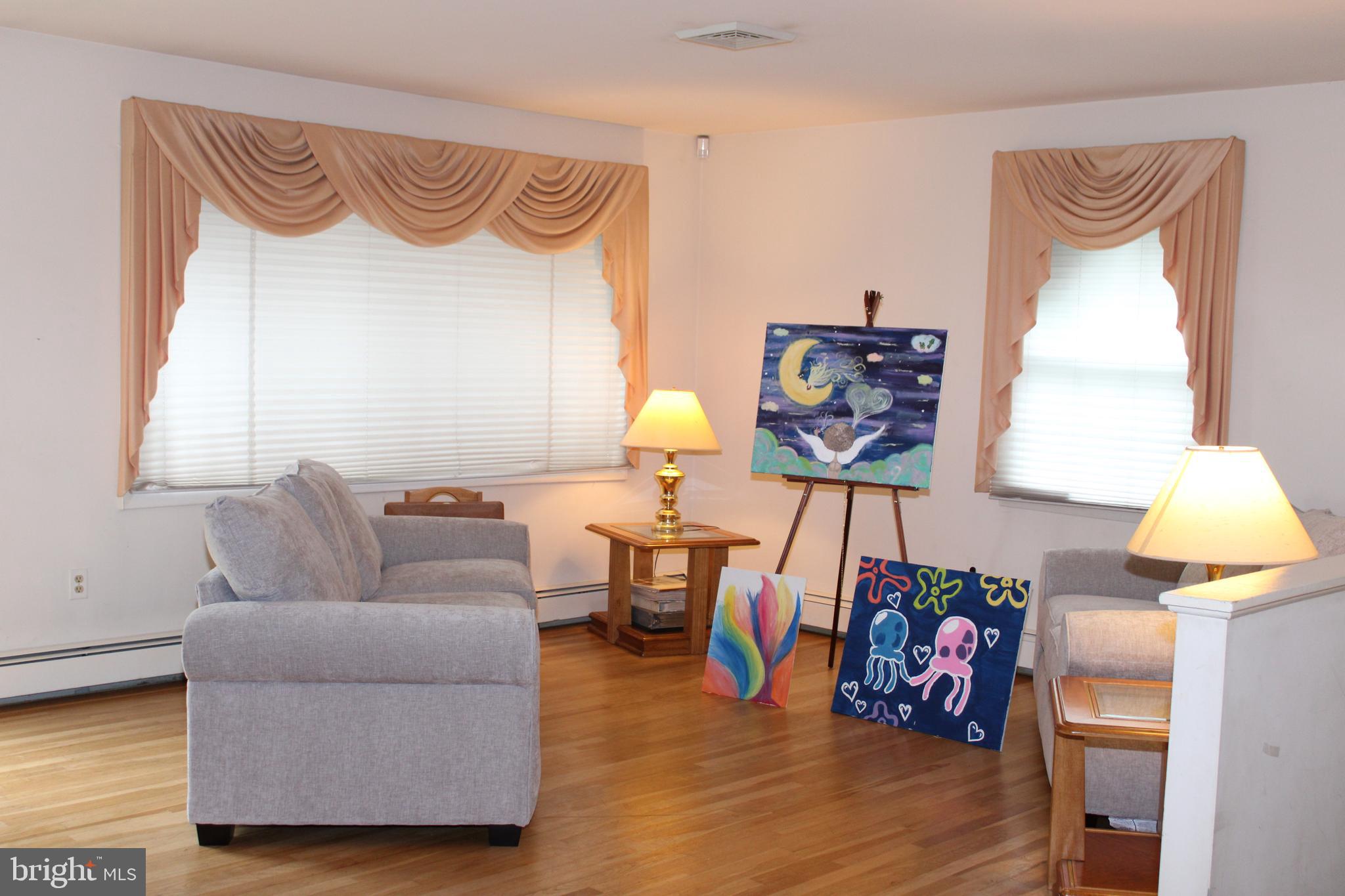 6036 Chesworth Road Baltimore, MD 21228 - Photo 4 of 15 a living room with furniture and wooden floor