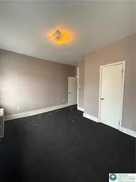 an empty room with a kitchen