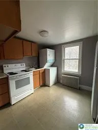 a kitchen with a stove a sink and a microwave
