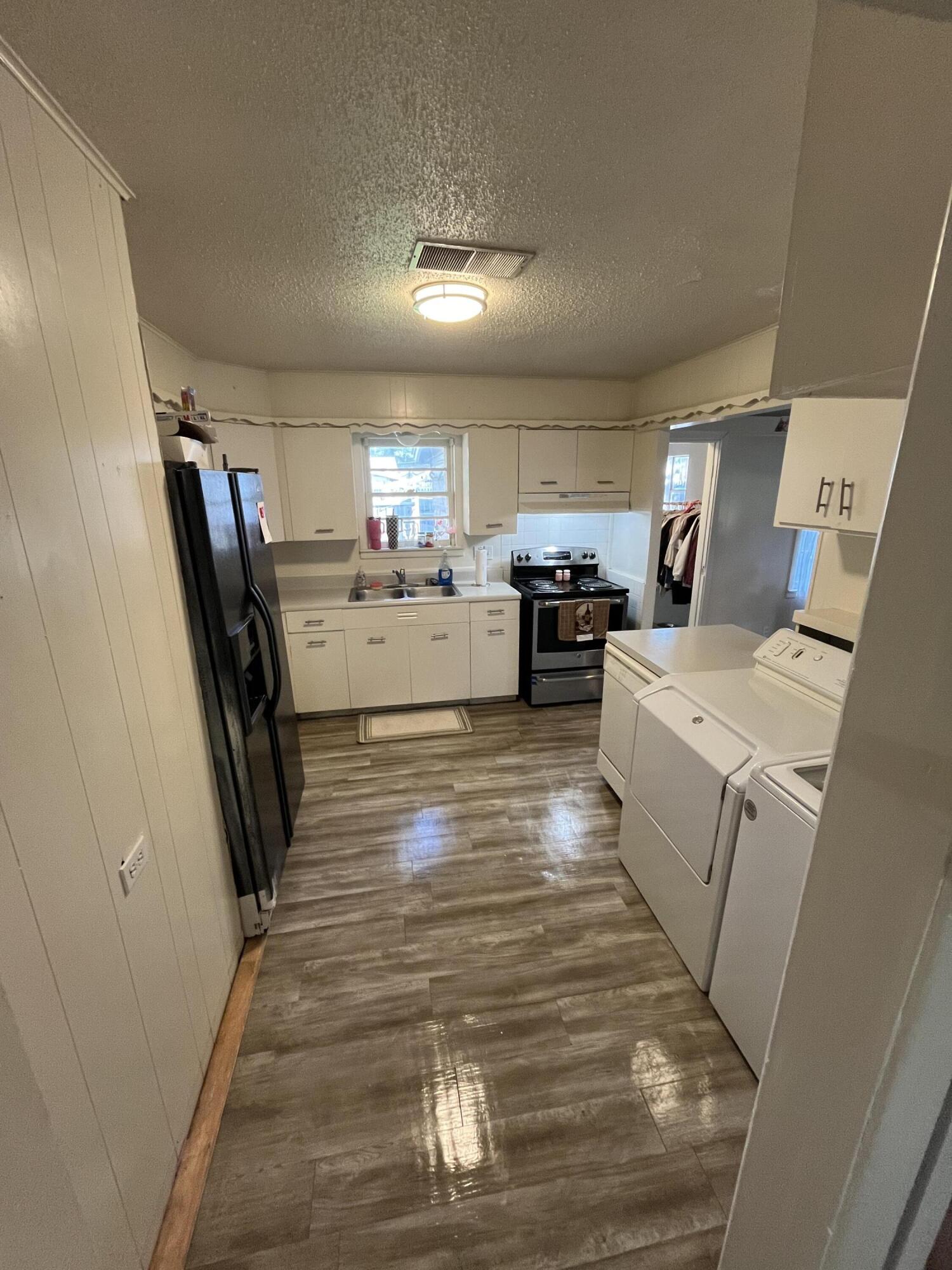 4907 38th Street Lubbock, TX 79414 - Photo 3 of 6 a room with a washer dryer and flat screen tv