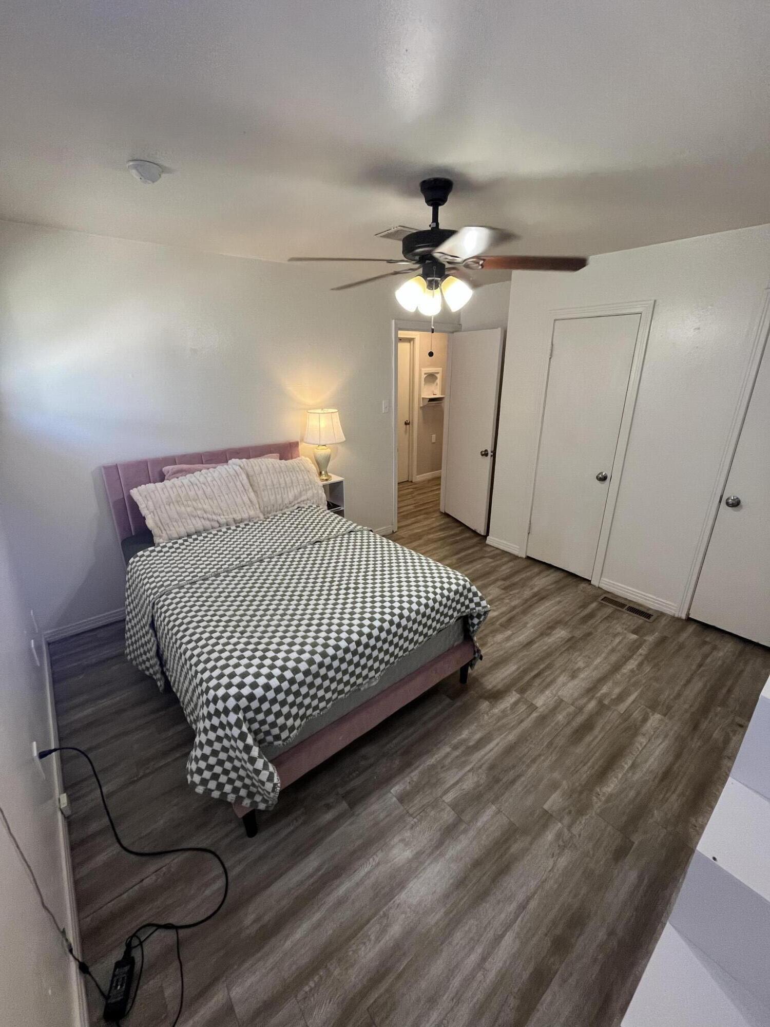 4907 38th Street Lubbock, TX 79414 - Photo 4 of 6 a bedroom with a bed and wooden floor