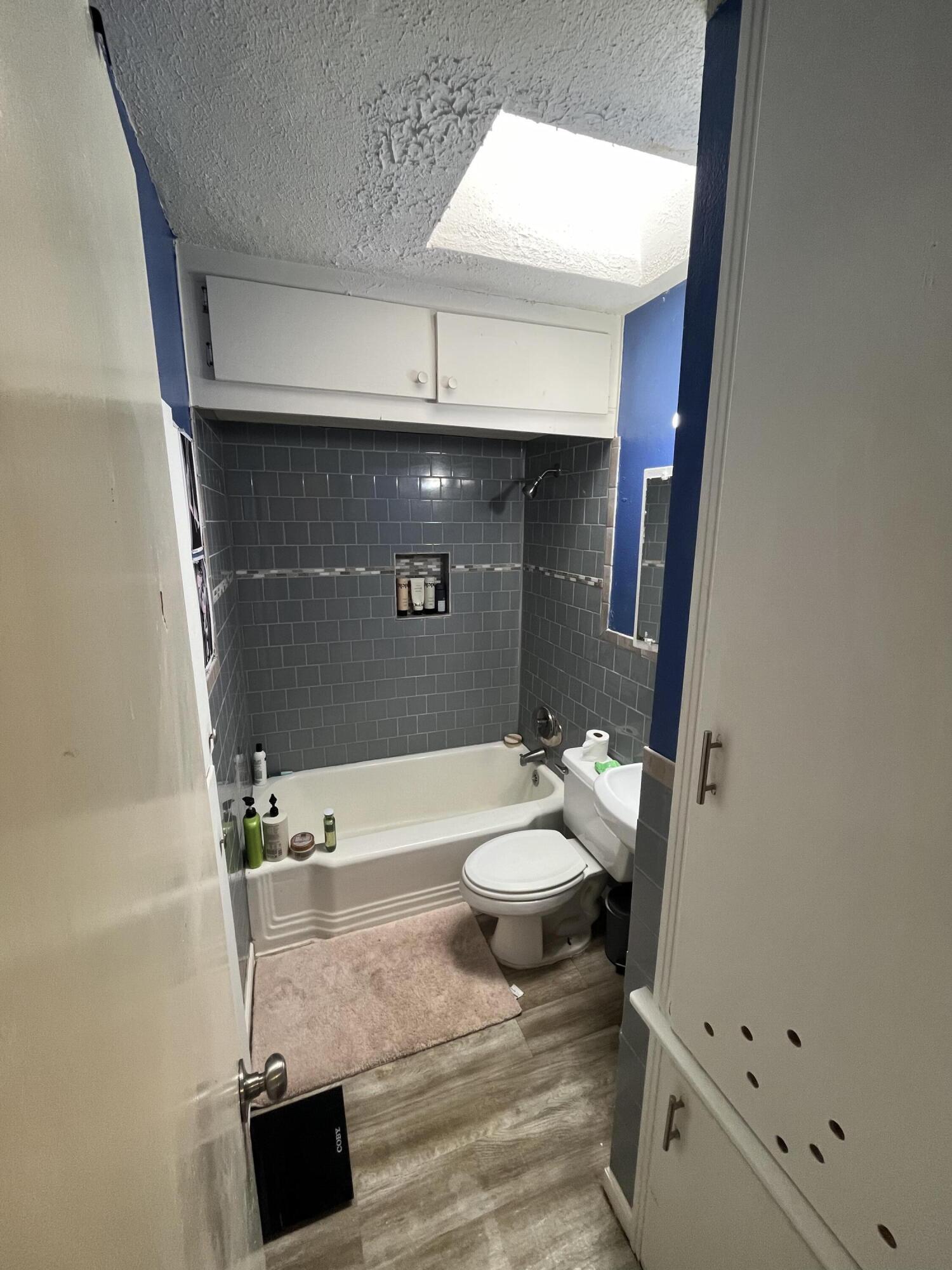 4907 38th Street Lubbock, TX 79414 - Photo 5 of 6 a bathroom with a sink a toilet and a shower