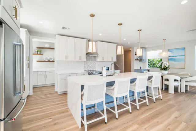 a large kitchen with a table and chairs