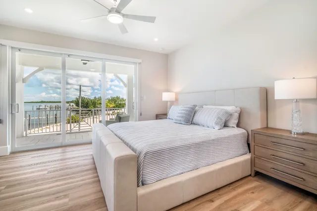 a bedroom with a large bed and a large window with outer view