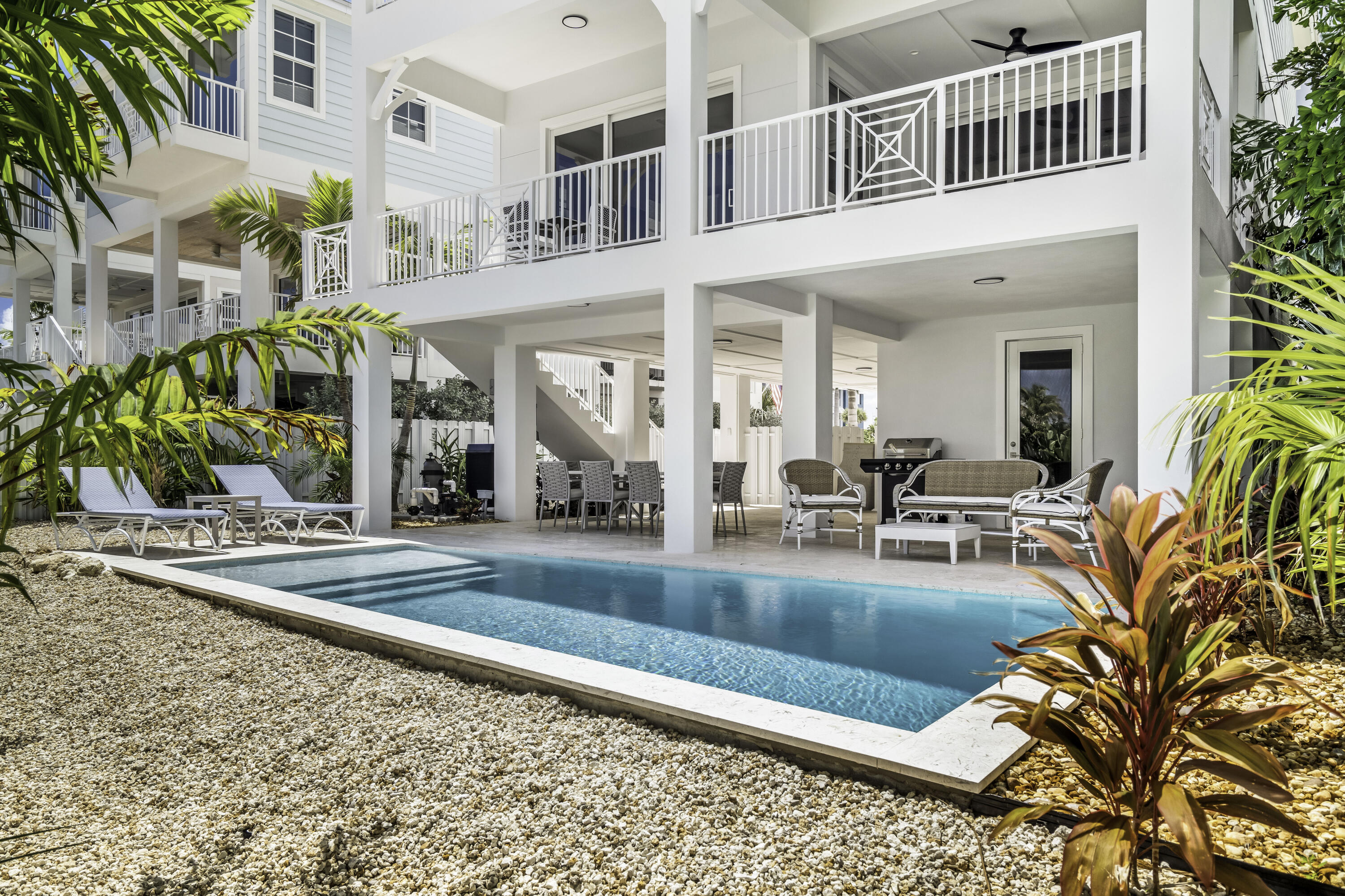 815 39th Street Marathon, FL 33050 - Photo 4 of 24 a view of a house with a swimming pool and sitting area