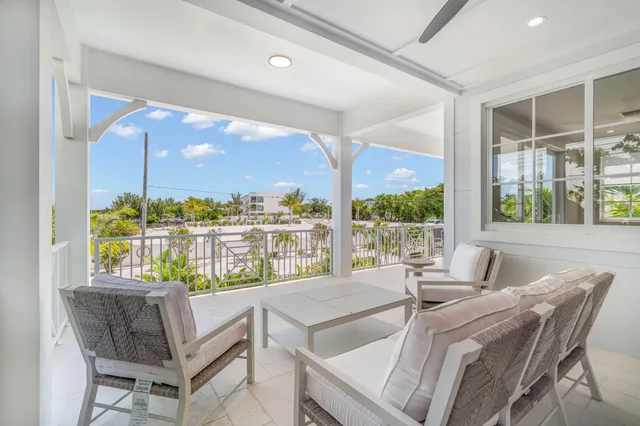 a dining room with furniture and a floor to ceiling window