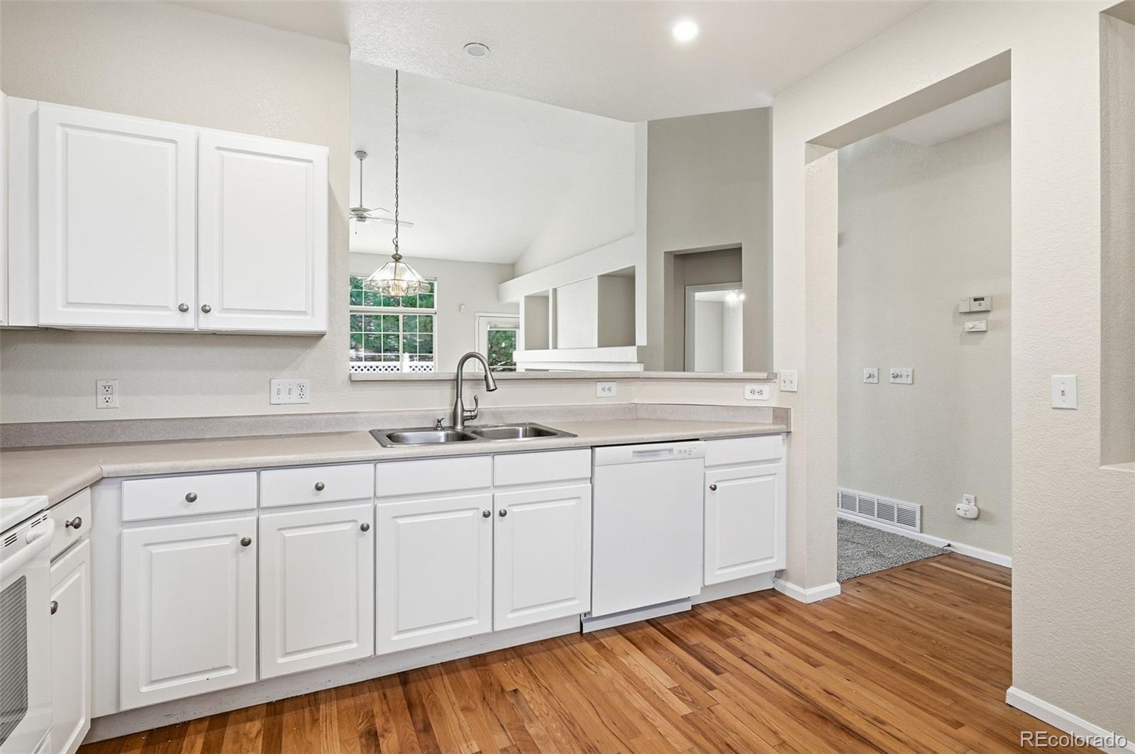 2526 South Tucson Circle Aurora, CO 80014 - Photo 17 of 33 a view of a kitchen with white cabinets