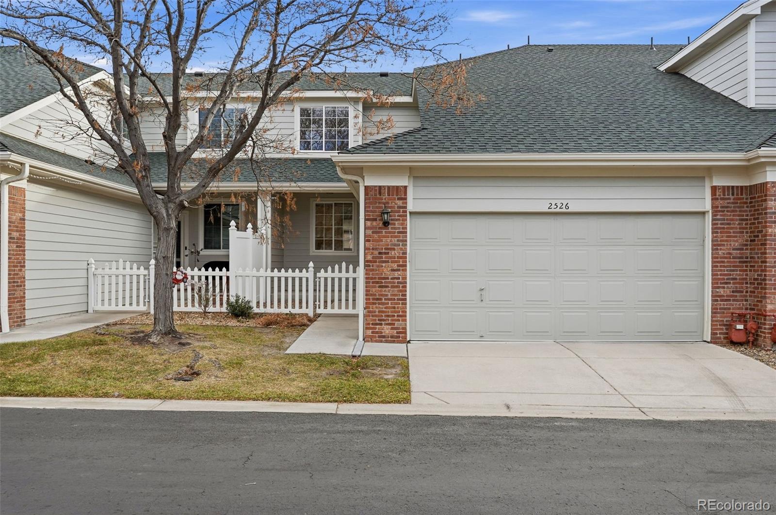 2526 South Tucson Circle Aurora, CO 80014 - Photo 2 of 33 a front view of a house with a yard and garage