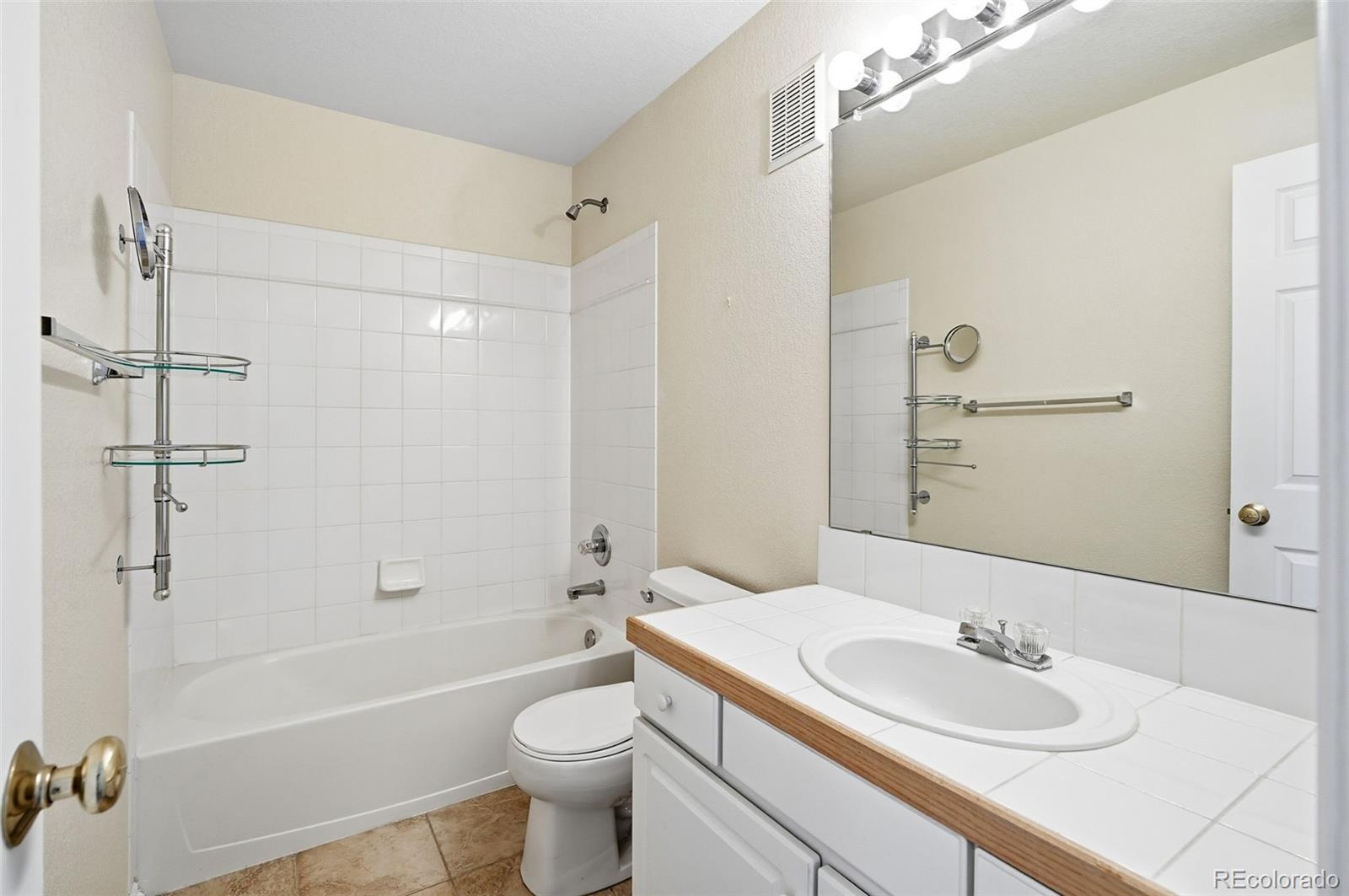 2526 South Tucson Circle Aurora, CO 80014 - Photo 28 of 33 a bathroom with a sink a toilet and shower