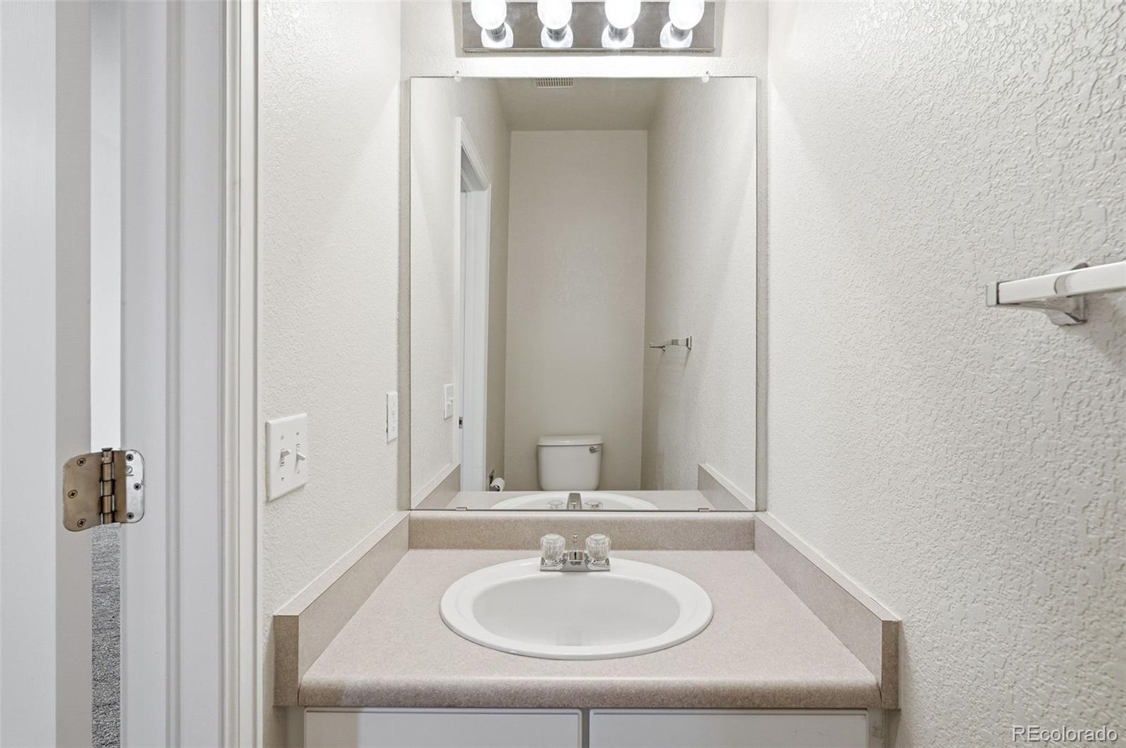 2526 South Tucson Circle Aurora, CO 80014 - Photo 8 of 33 a bathroom with a sink and a mirror