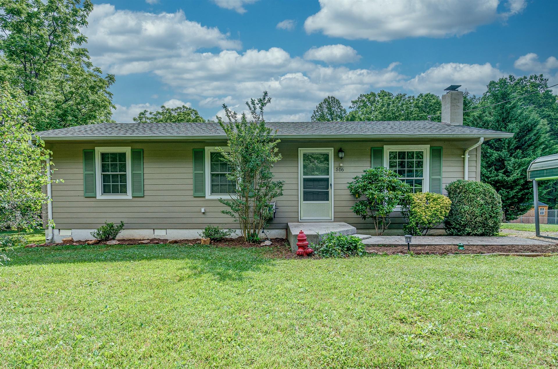 a front view of a house with a garden and plants