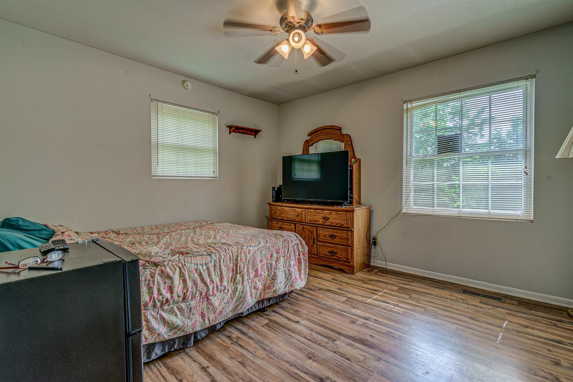 516 Jefferson Dock Road Penhook, VA 24137 - Photo 11 of 20 a bedroom with a bed and a tv on the dresser