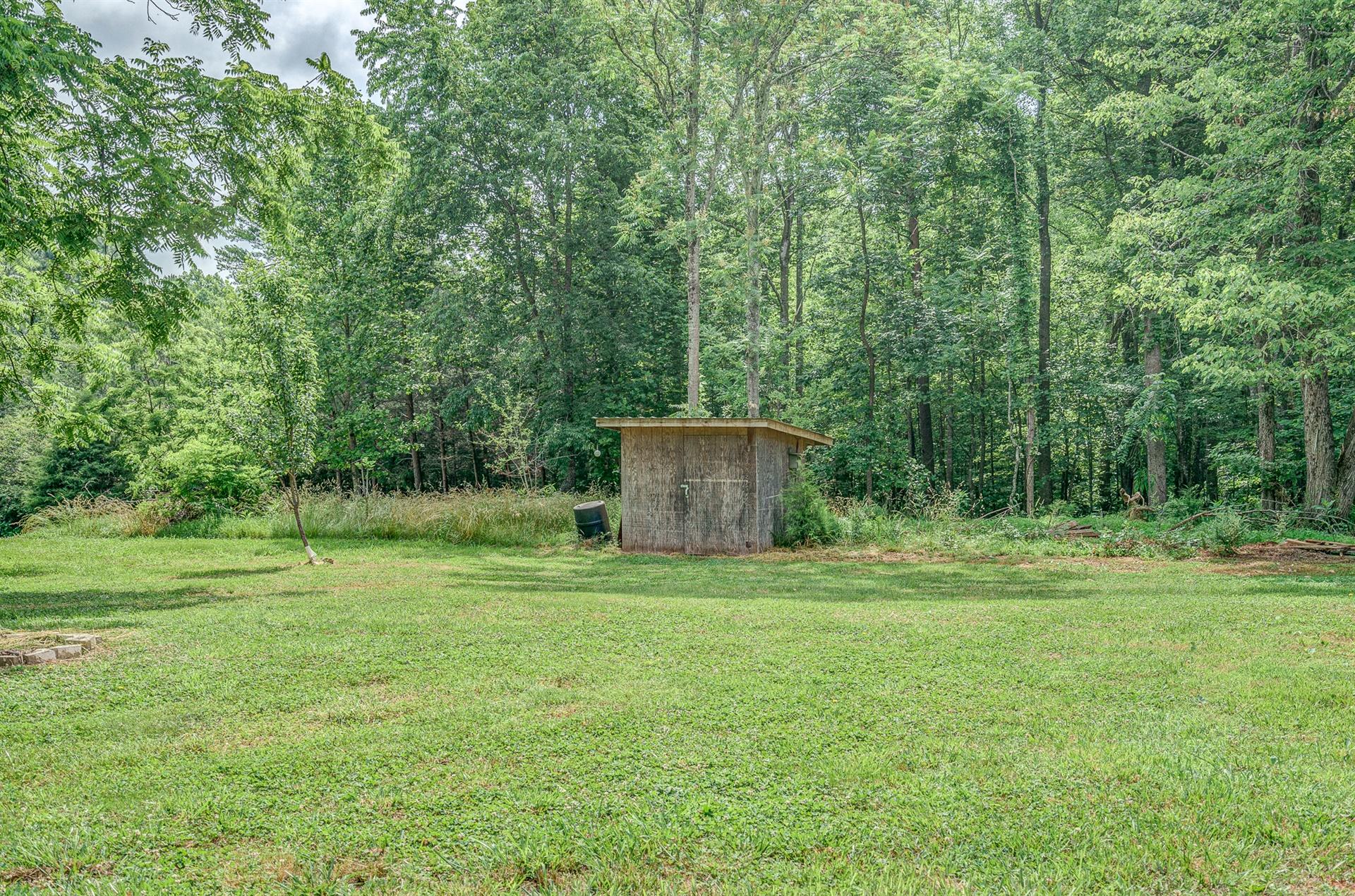 516 Jefferson Dock Road Penhook, VA 24137 - Photo 17 of 20 a backyard of a house with lots of green space and chair