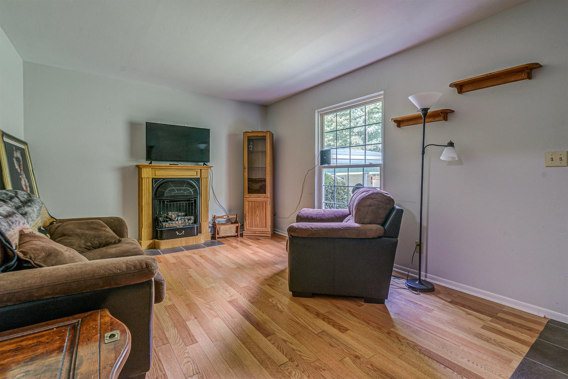516 Jefferson Dock Road Penhook, VA 24137 - Photo 4 of 20 a living room with furniture and a fireplace