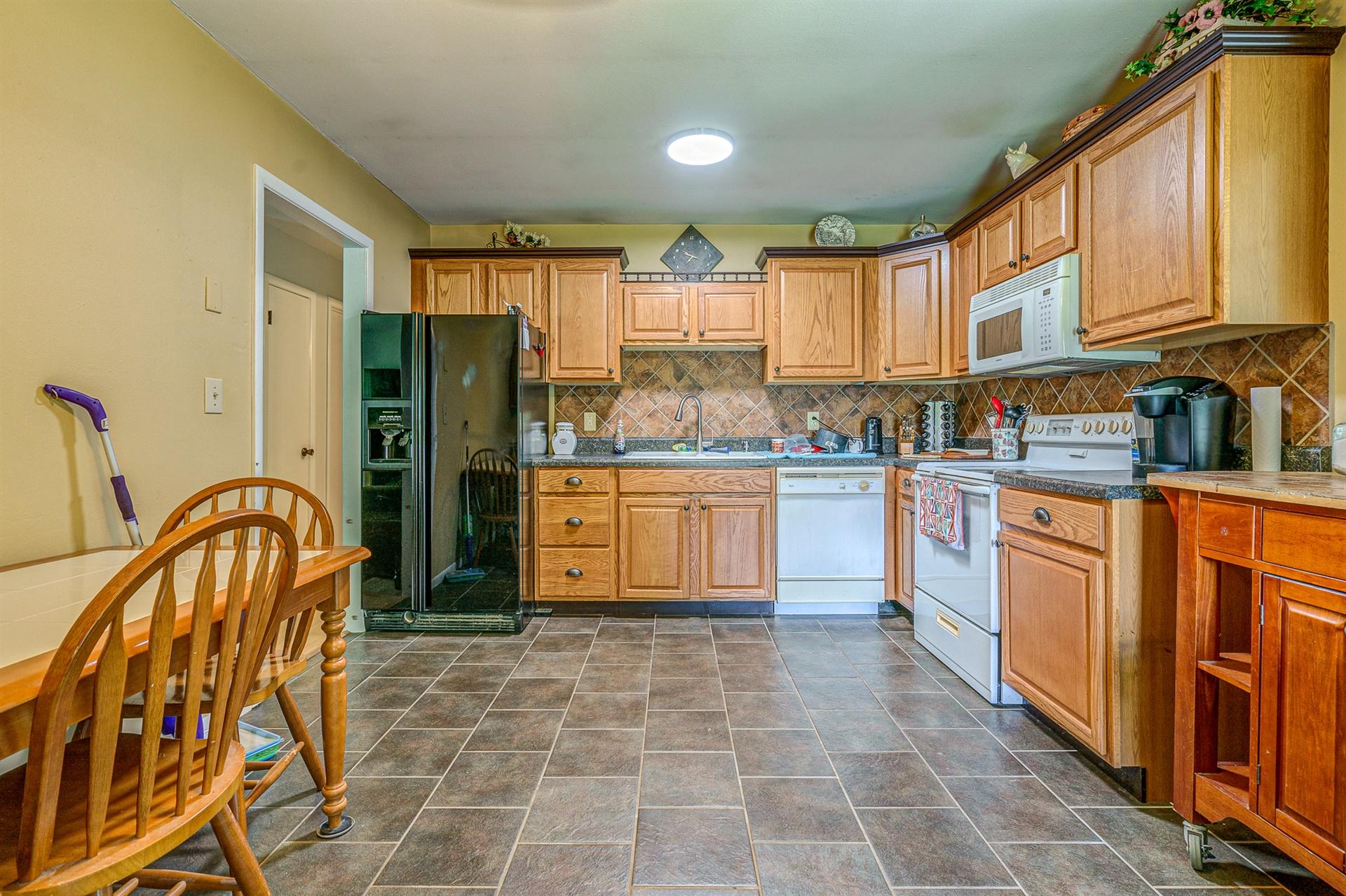 516 Jefferson Dock Road Penhook, VA 24137 - Photo 6 of 20 a kitchen with stainless steel appliances granite countertop a stove top oven a sink dishwasher and cabinets