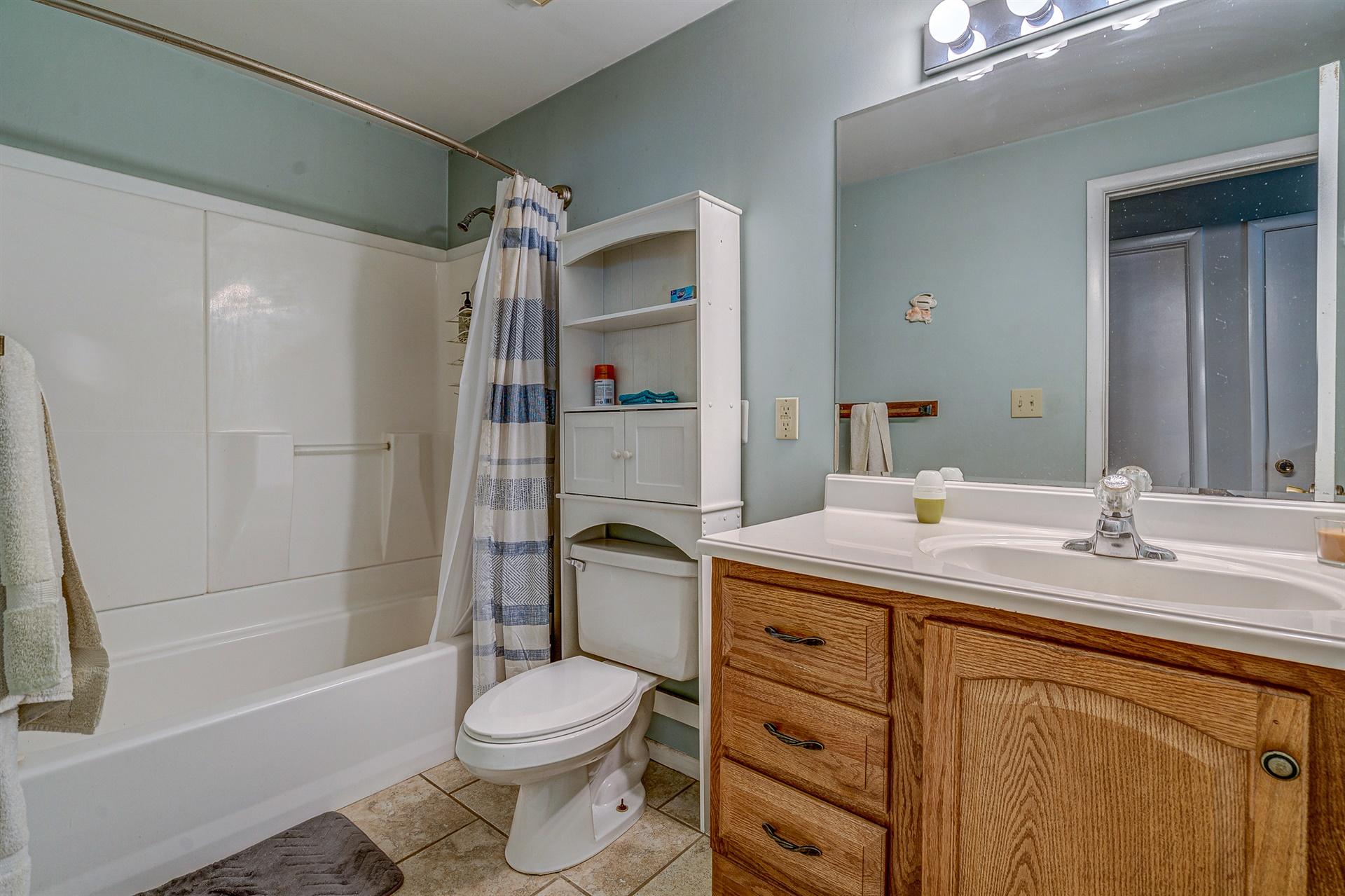 516 Jefferson Dock Road Penhook, VA 24137 - Photo 9 of 20 a bathroom with a granite countertop sink toilet mirror and shower