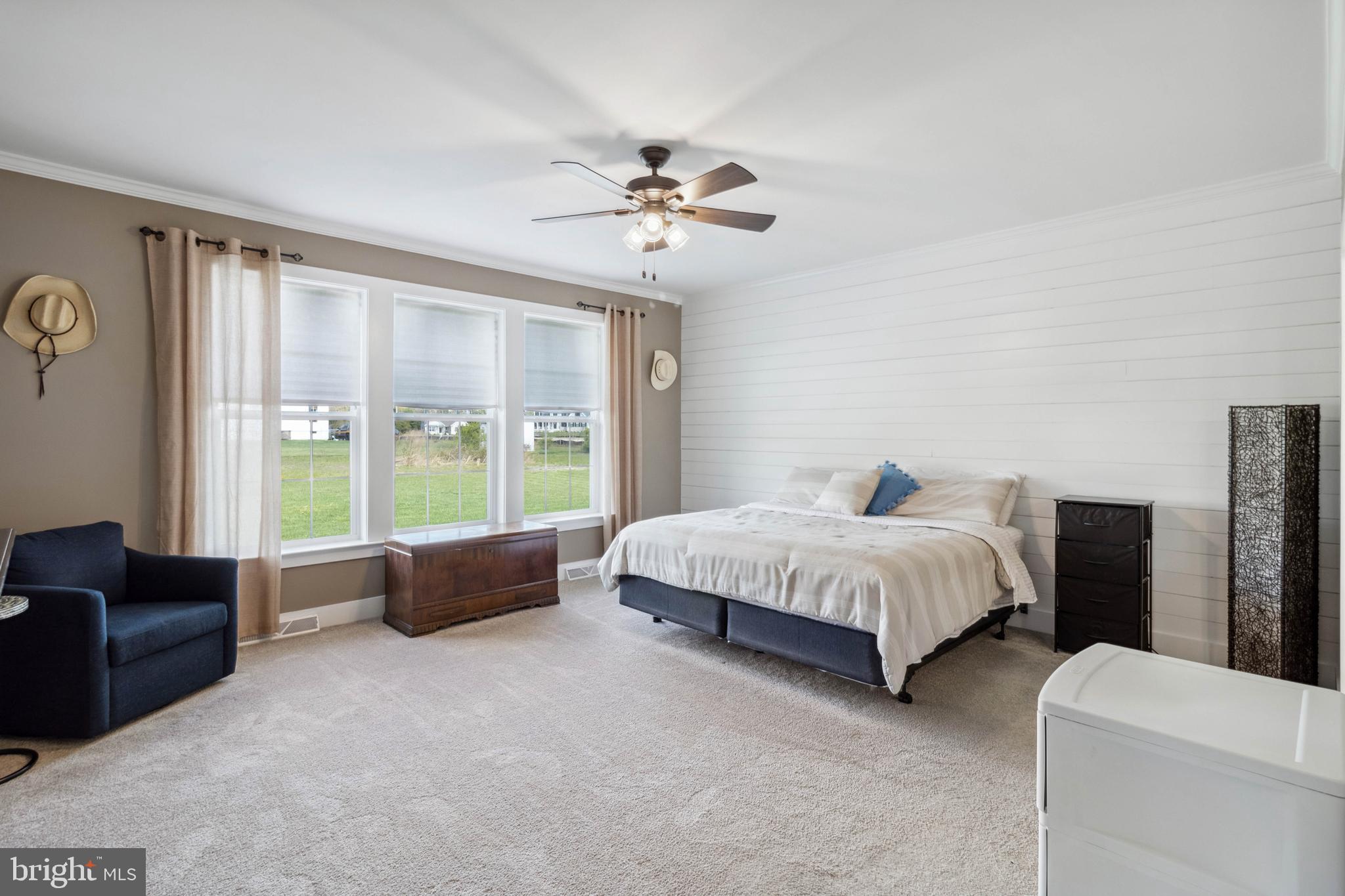 24019 Ingrams Drive Millsboro, DE 19966 - Photo 15 of 49 a spacious bedroom with a bed and a couch
