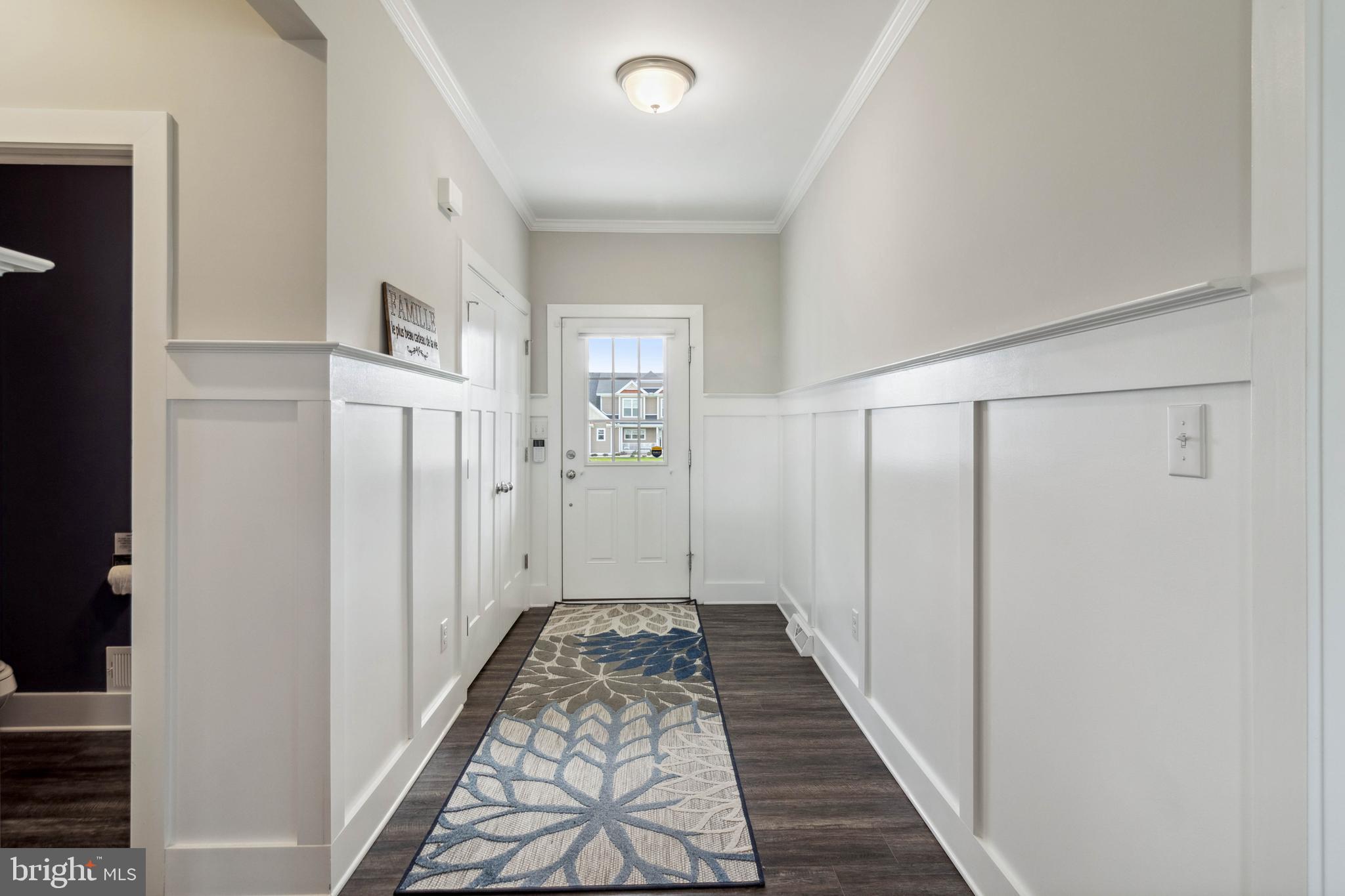 24019 Ingrams Drive Millsboro, DE 19966 - Photo 35 of 49 a view of a hallway with wooden floor and a bathroom