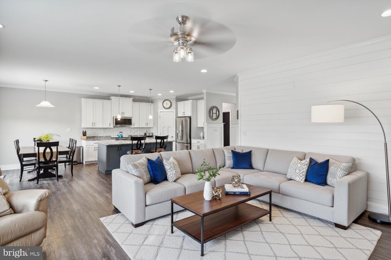 24019 Ingrams Drive Millsboro, DE 19966 - Photo 8 of 49 a living room with furniture kitchen view and a chandelier