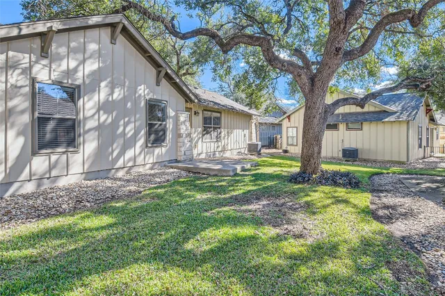 a backyard of a house with outdoor seating and yard