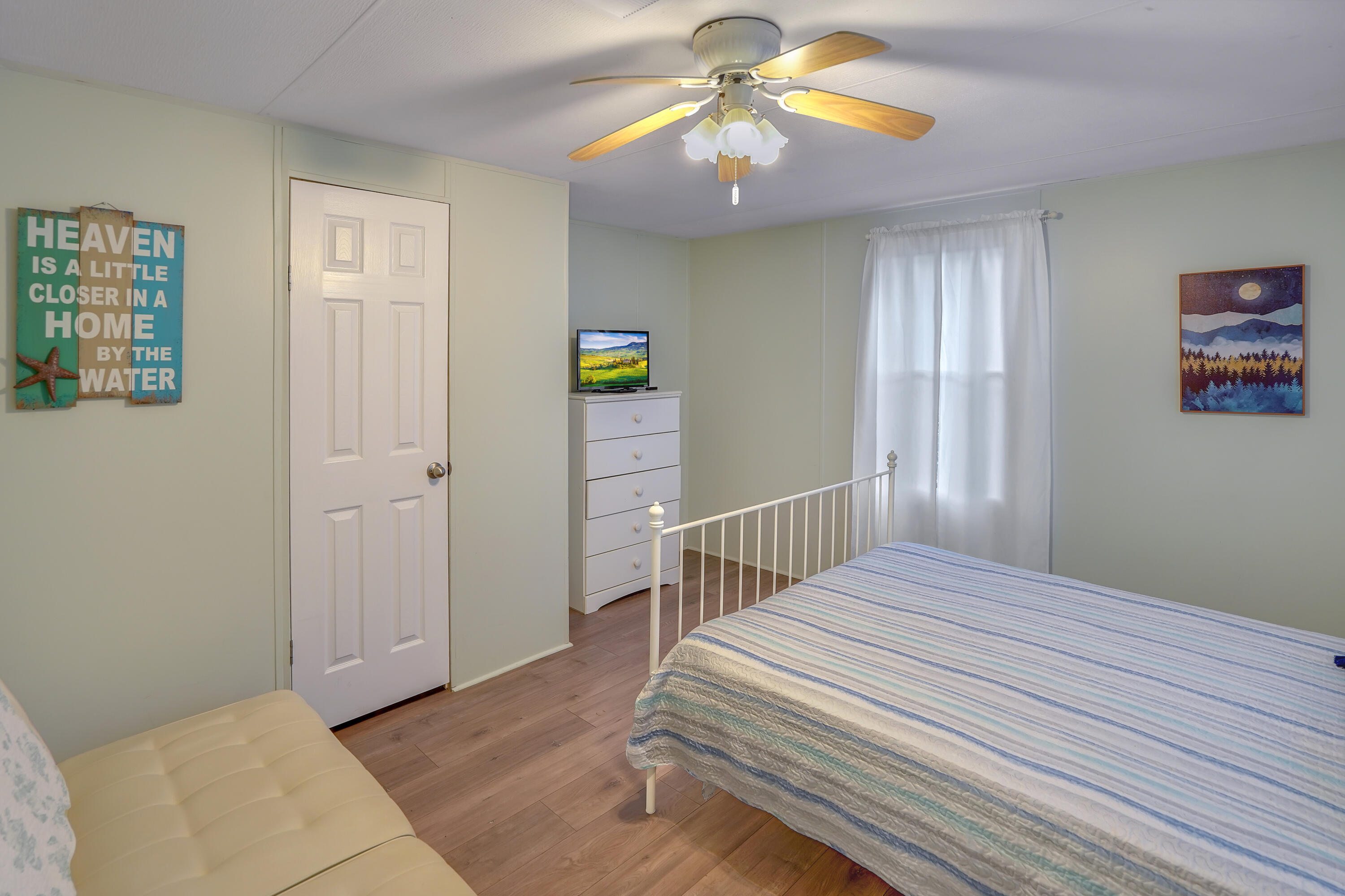 518 Ridgelake Road Goodview, VA 24095 - Photo 13 of 27 a bedroom with a bed and a chandelier