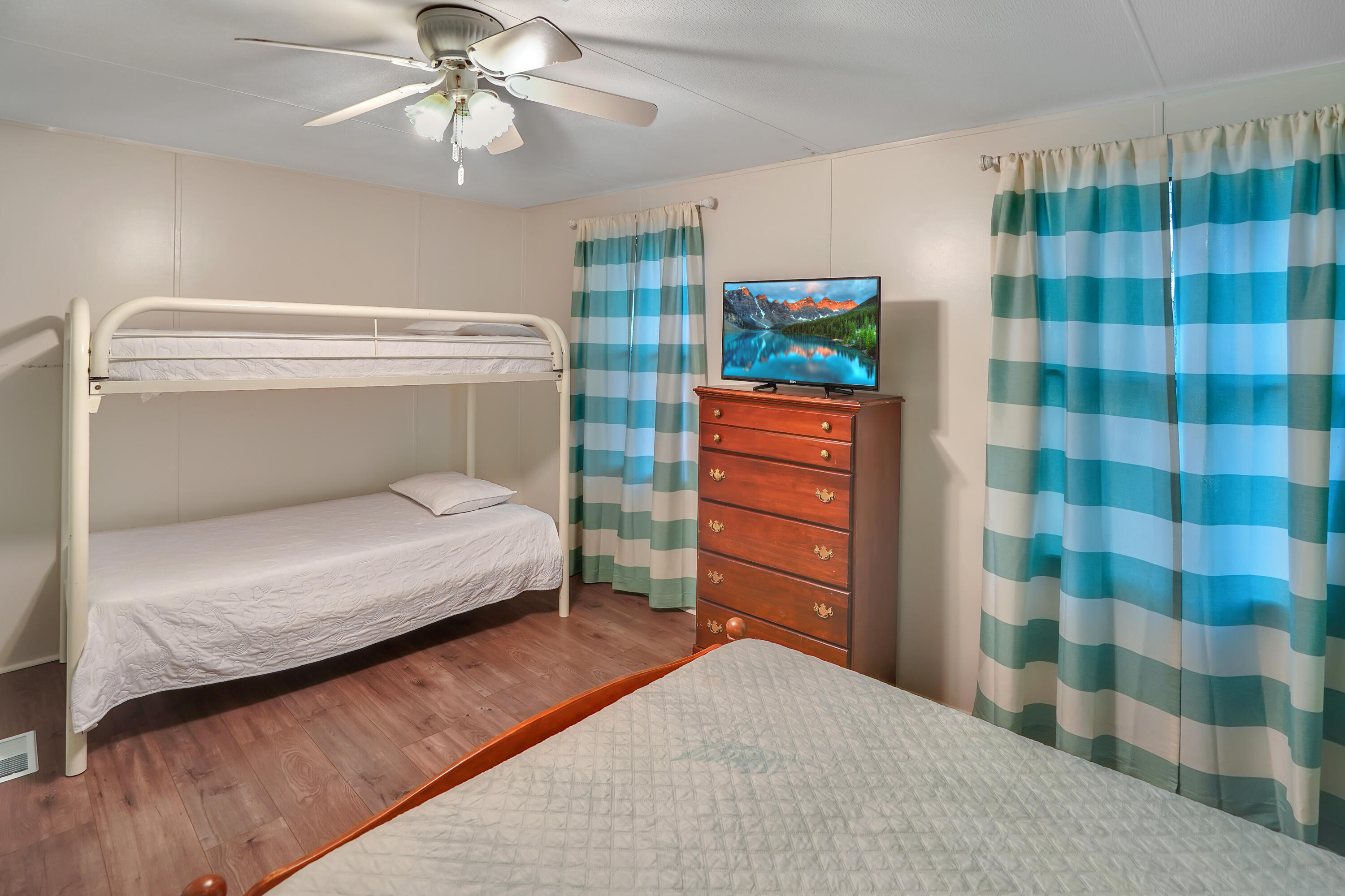 518 Ridgelake Road Goodview, VA 24095 - Photo 8 of 27 a bedroom with a bed and a chandelier