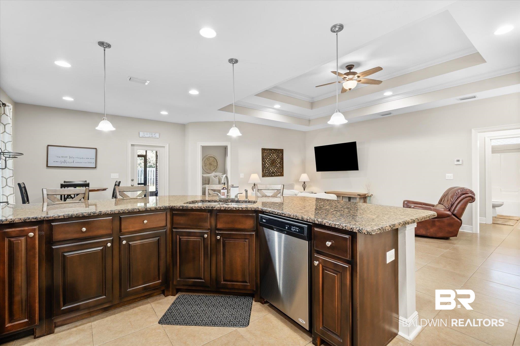 22640 Nana Loop East Silverhill, AL 36576 - Photo 6 of 46 Kitchen featuring light stone counters, sink, stainless steel dishwasher, and decorative light fixtures