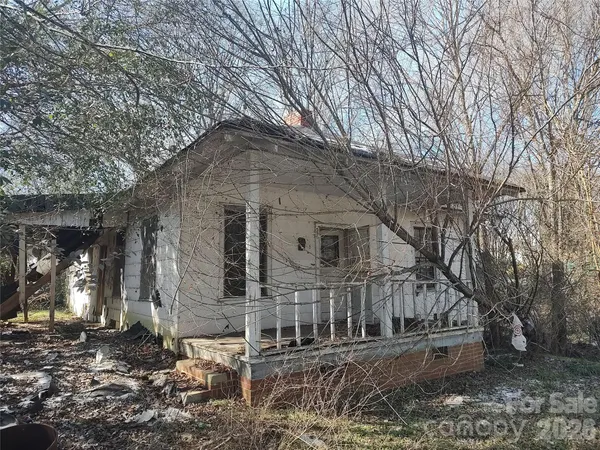 a brick house with trees in front of it