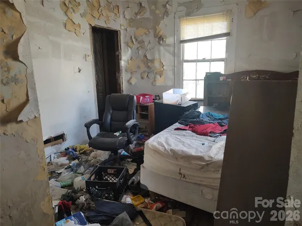 a bedroom with furniture and a window