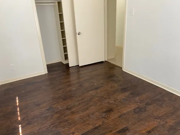 a view of a room with wooden floor