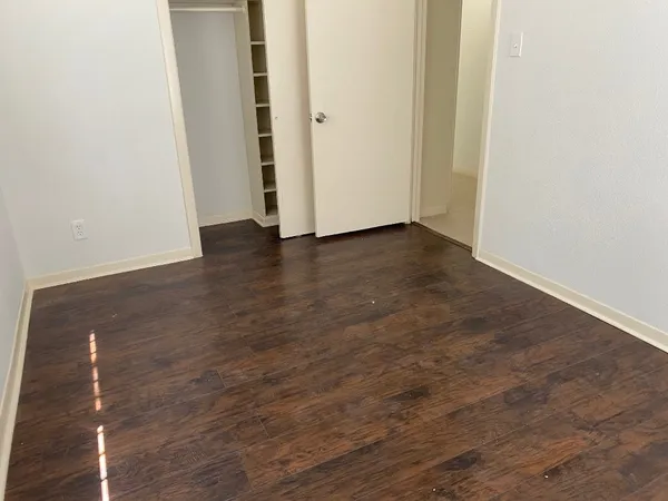 an empty room with wooden floor