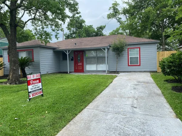 a front view of house with yard and tree