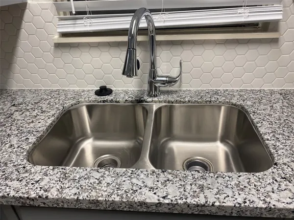 a kitchen with stainless steel appliances a sink and a stove