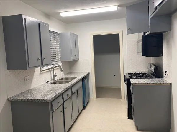 a bathroom with a granite countertop shower
