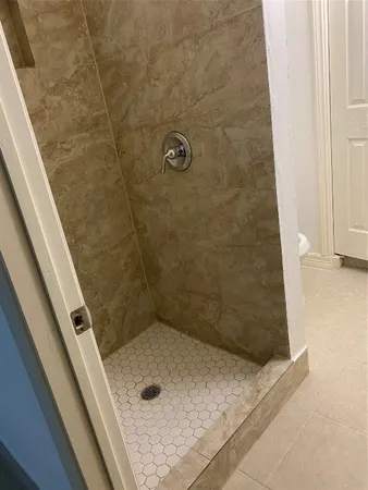 a white toilet sitting next to a sink