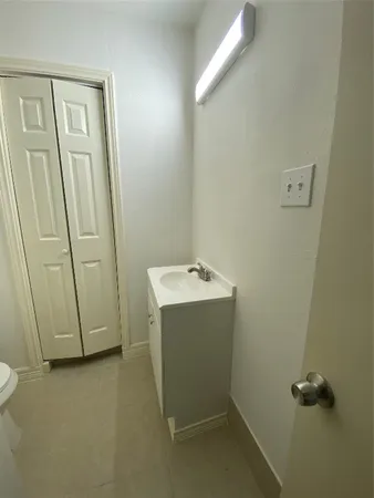 a white toilet sitting next to a sink