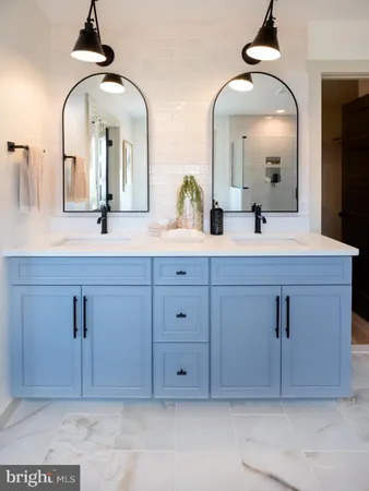 a bathroom with a double vanity sink and a mirror