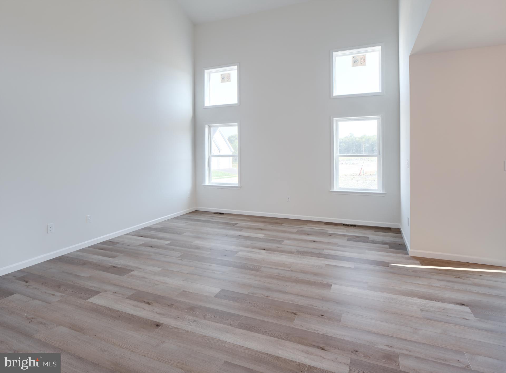 707007728 Hook Road, Unit MAGNOLIA Westminster, MD 21157 - Photo 9 of 20 an empty room with wooden floor and windows