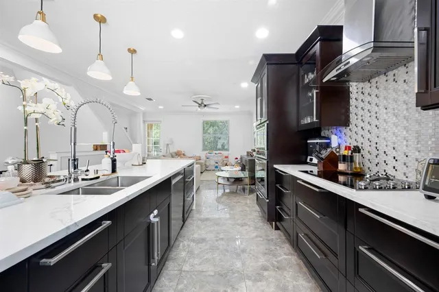 a large kitchen with kitchen island a sink stainless steel appliances and cabinets